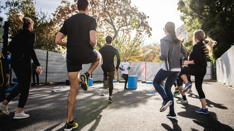 A person doing an early morning run in cool dawn light through a park, motion blur on the legs, sharp focus on the expression of calm effort