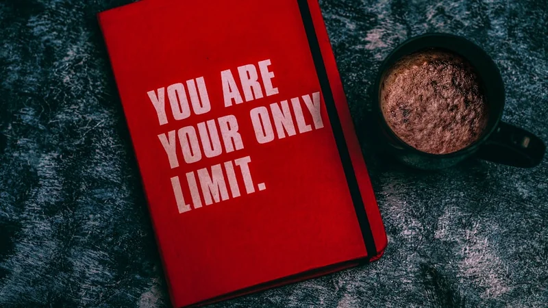 Open journal with handwritten affirmations on a wooden desk, natural light, coffee cup beside it