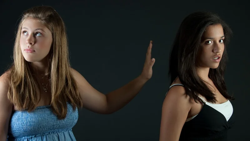 Two people having a deep, open conversation over coffee with genuine smiles
