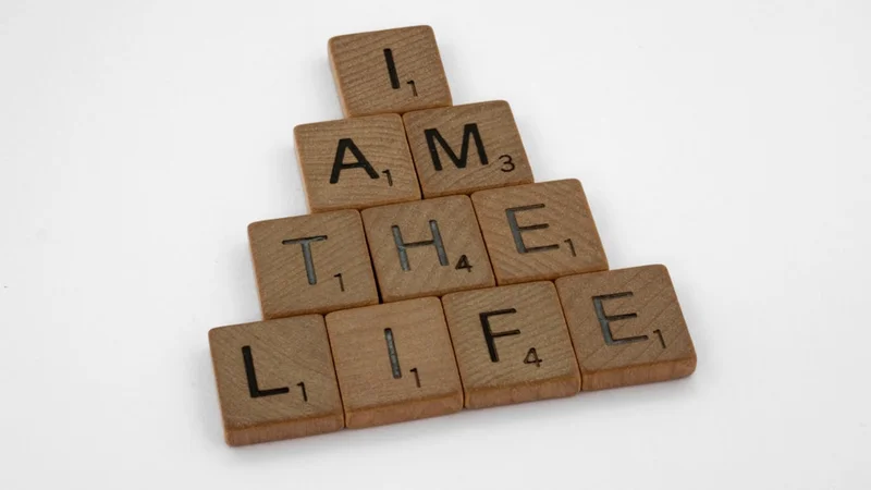Open journal on a wooden desk with three words written and circled — "Freedom, Creativity, Family" — beside a cup of coffee